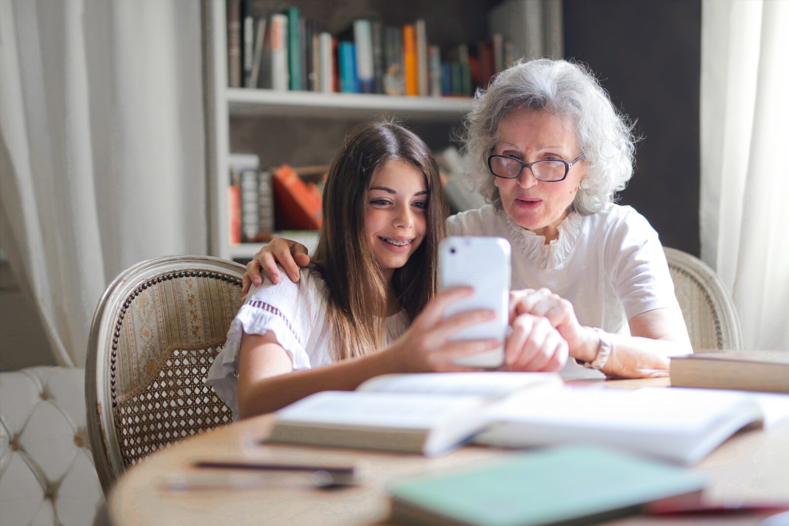 Showing Her Cellphone To Her Grandmother
